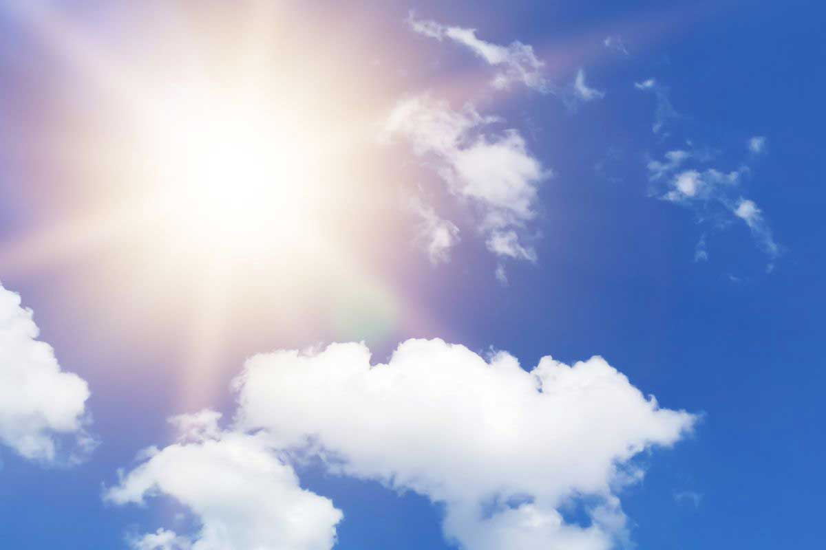 sunshining bright through the clouds and bright blue sky
