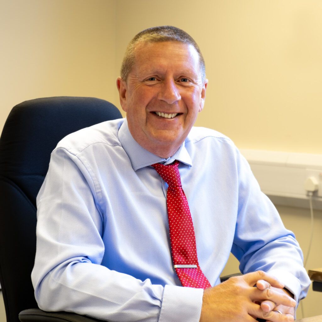 David Brayshaw - MD at Aqua Engineering sitting at his desk smiling