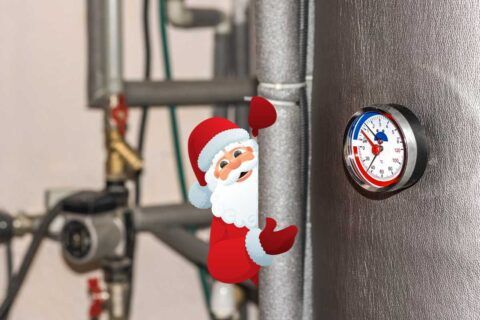 a humorous graphic of Santa clinging to an insulated water pipe in a domestic boiler room