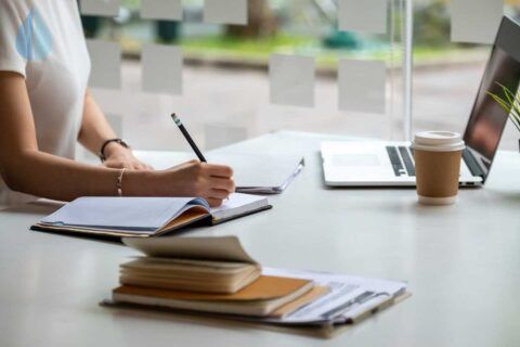 a female student studies an online training course at her desk