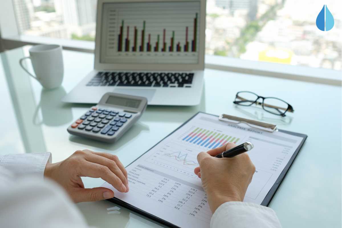 Woman sat a desk analysing data for a water audit.