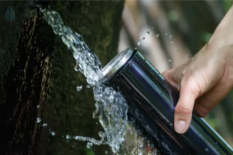 Filling a water bottle from a water spring